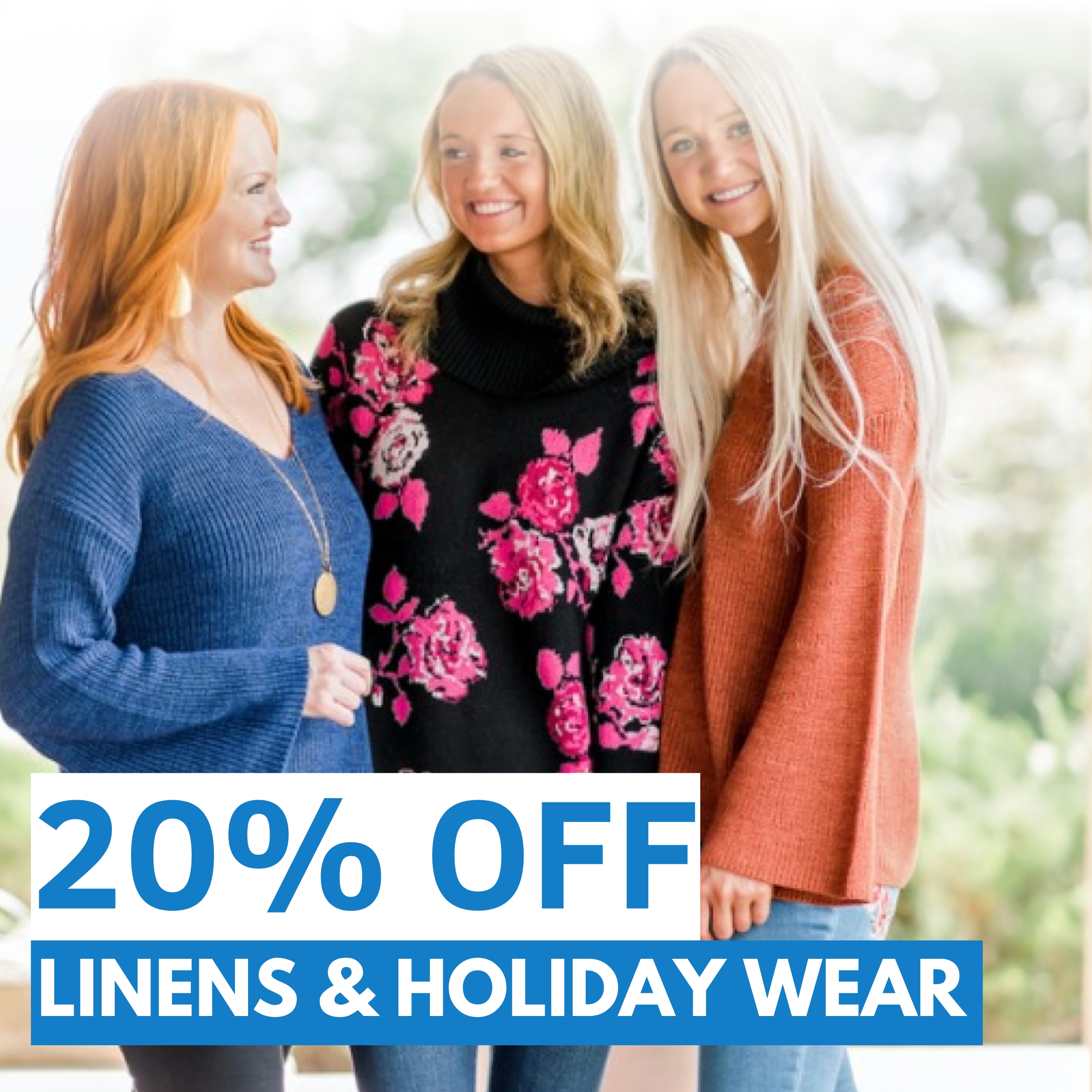 Three women wearing sweaters stand together smiling, with text in front that reads "20% OFF LINENS & HOLIDAY WEAR.
